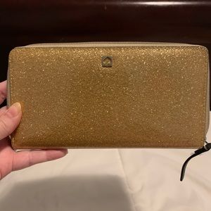 NWT Kate Spade Mavis Street gold wallet.